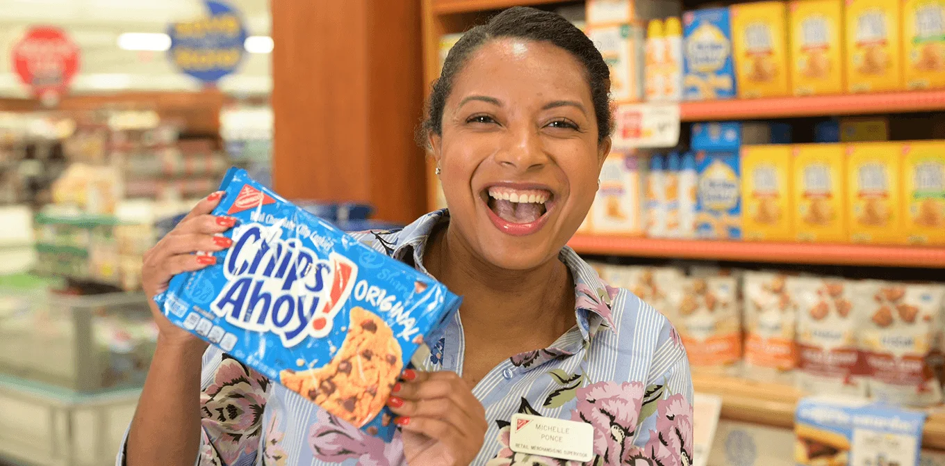 woman smiling holding a bag of chips ahoy